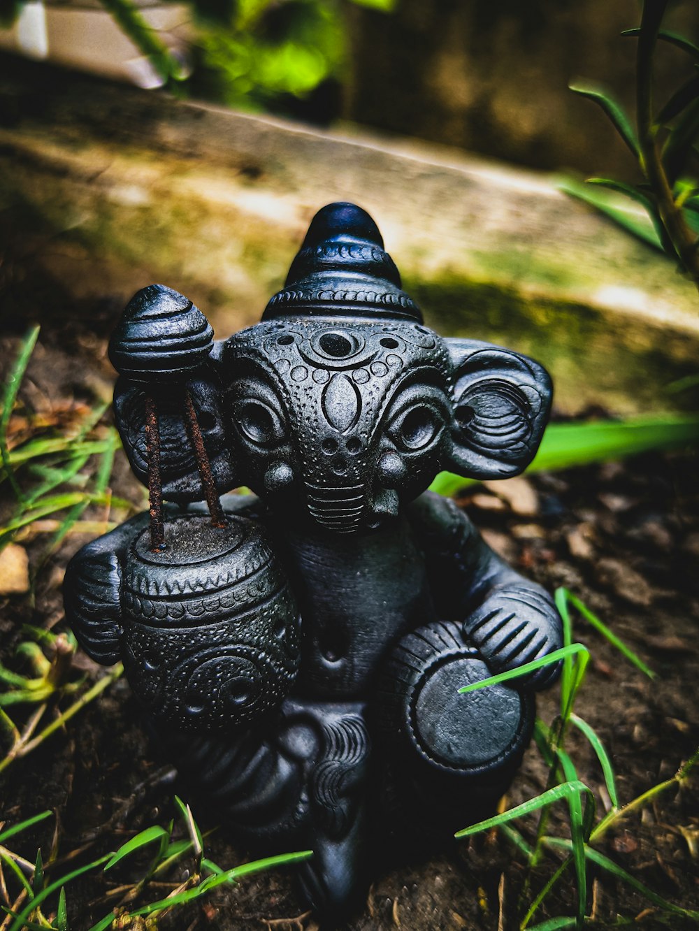 black dragon figurine on brown soil