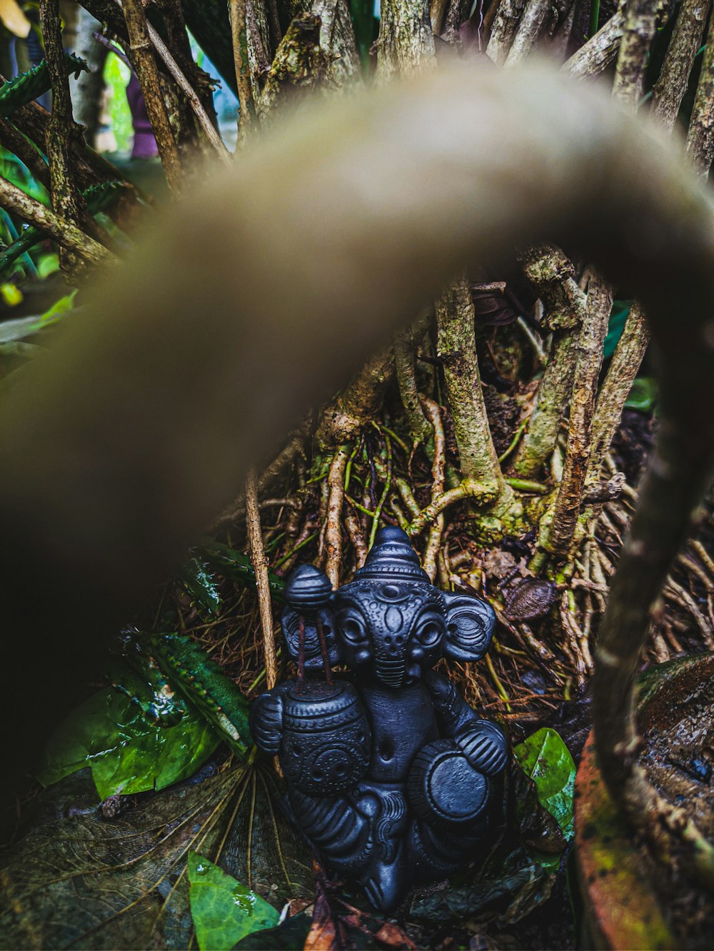 black dragon figurine on brown tree branch