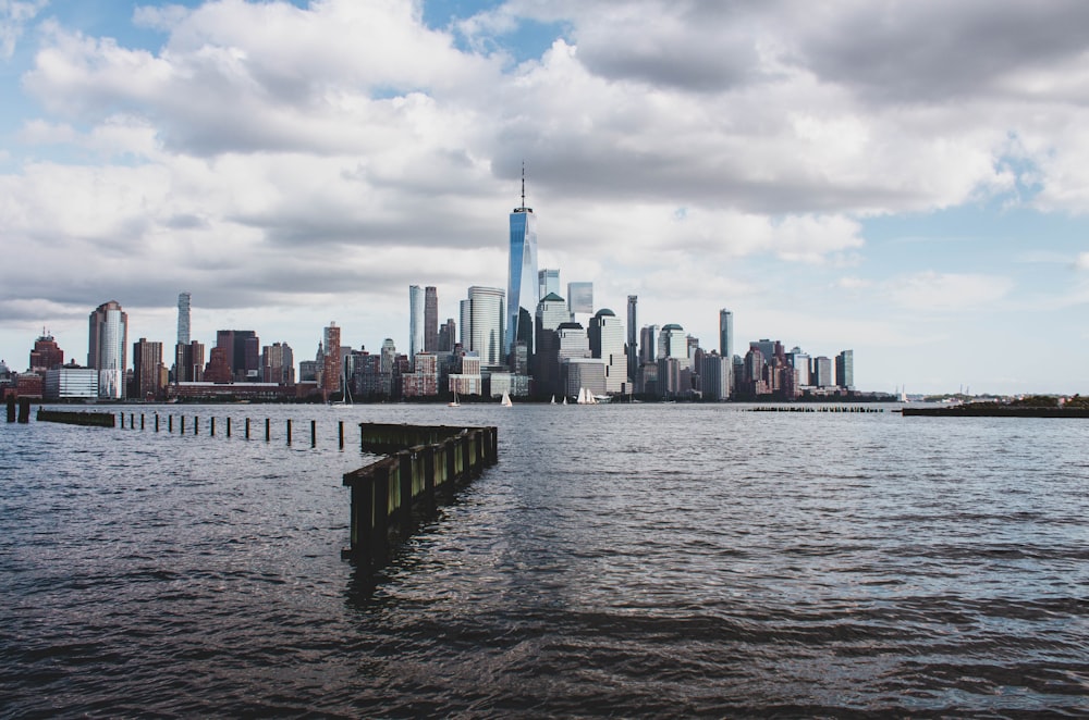 city skyline across body of water during daytime