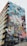 A building features a large, colorful mural depicting a woman in a ballet pose, seemingly leaping into the air with the city skyline in the background. The mural consists of vivid blocks of color and various artistic patterns.