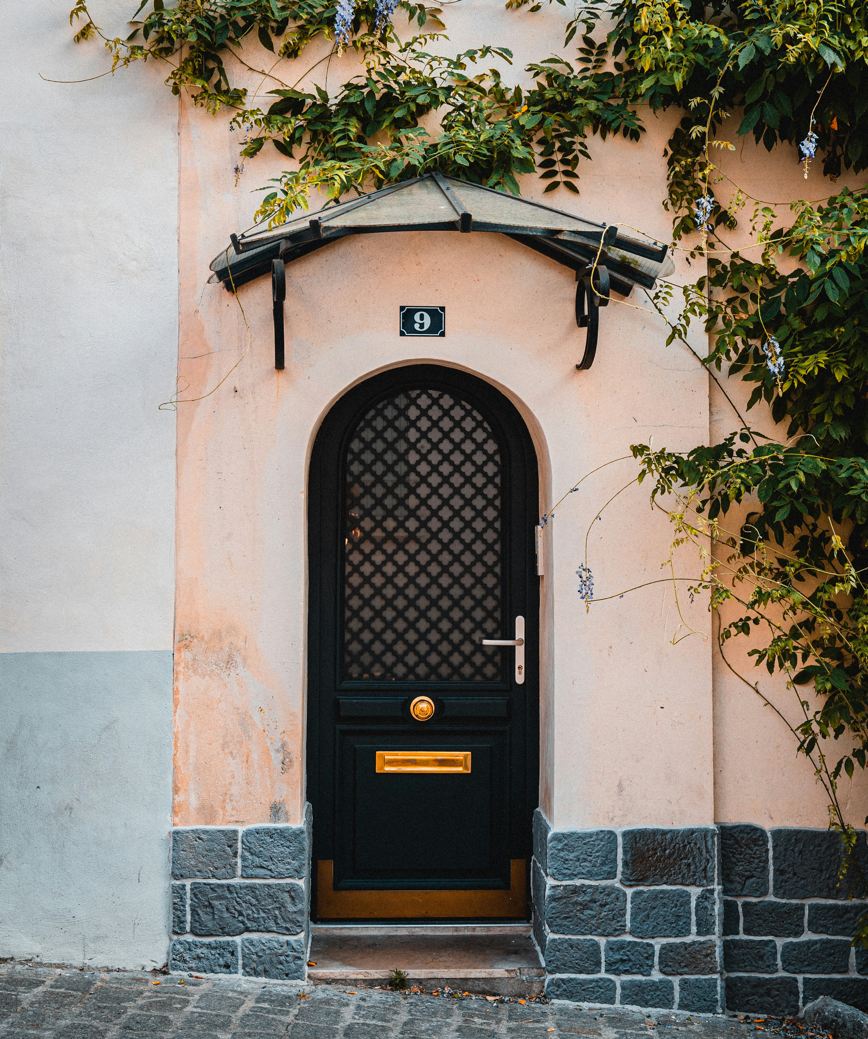 brown wooden door on white concrete wall