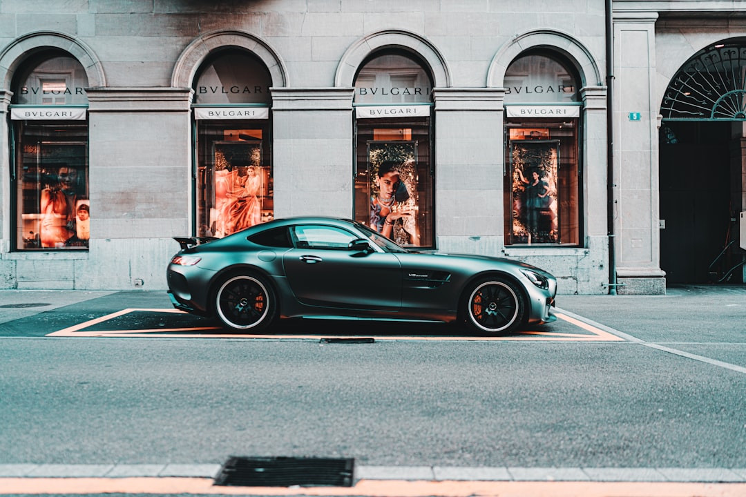 black coupe parked in front of building