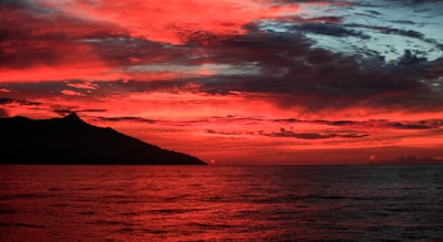 body of water under cloudy sky during sunset papua new guinea teams background