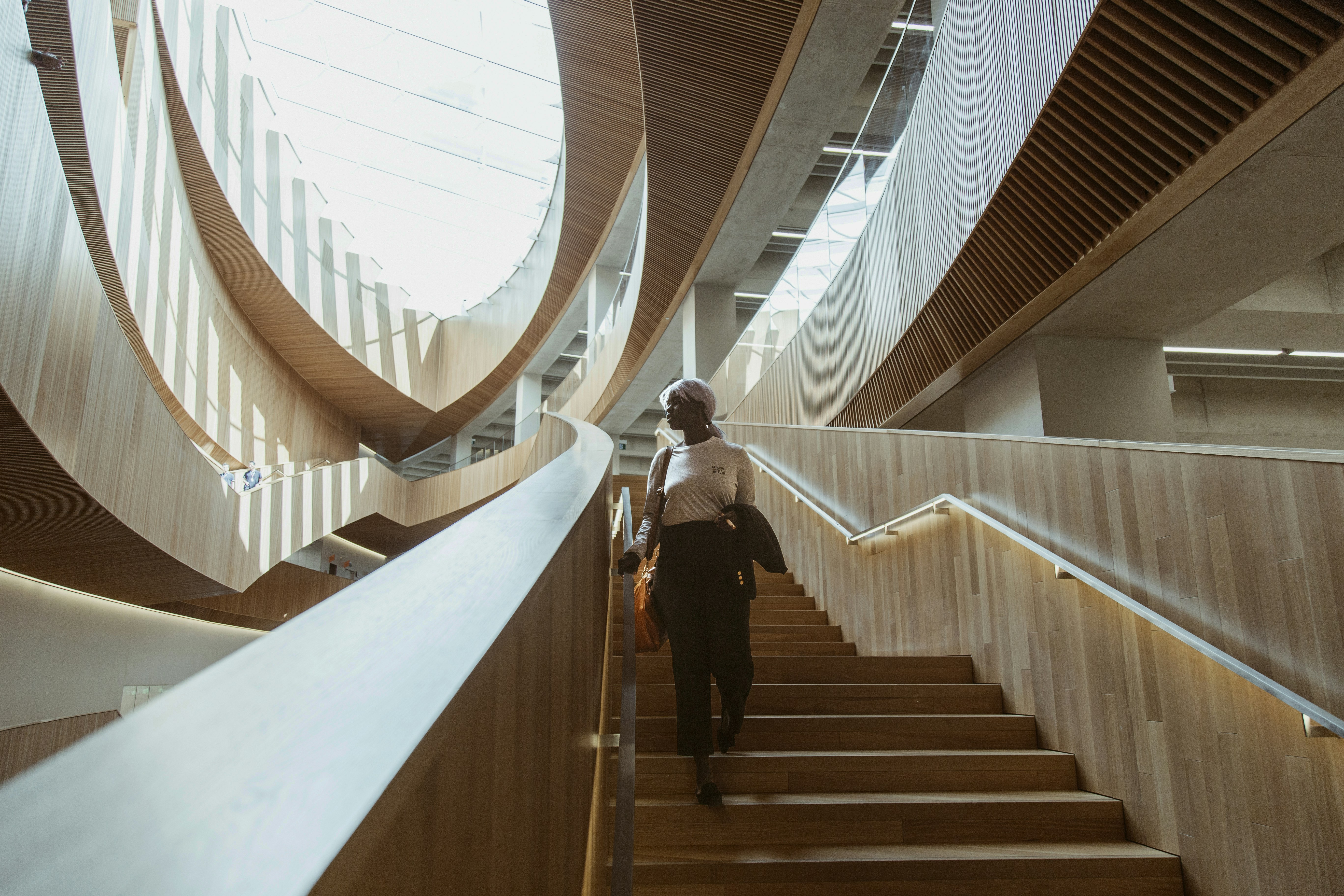 man in black jacket and black pants walking down the stairs