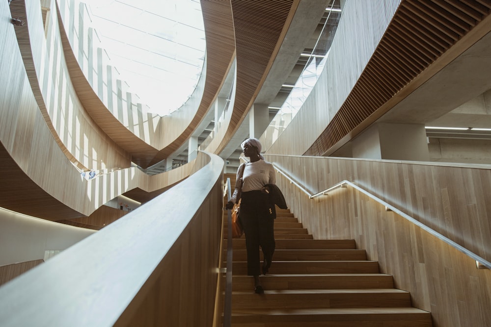 man in black jacket and black pants walking down the stairs