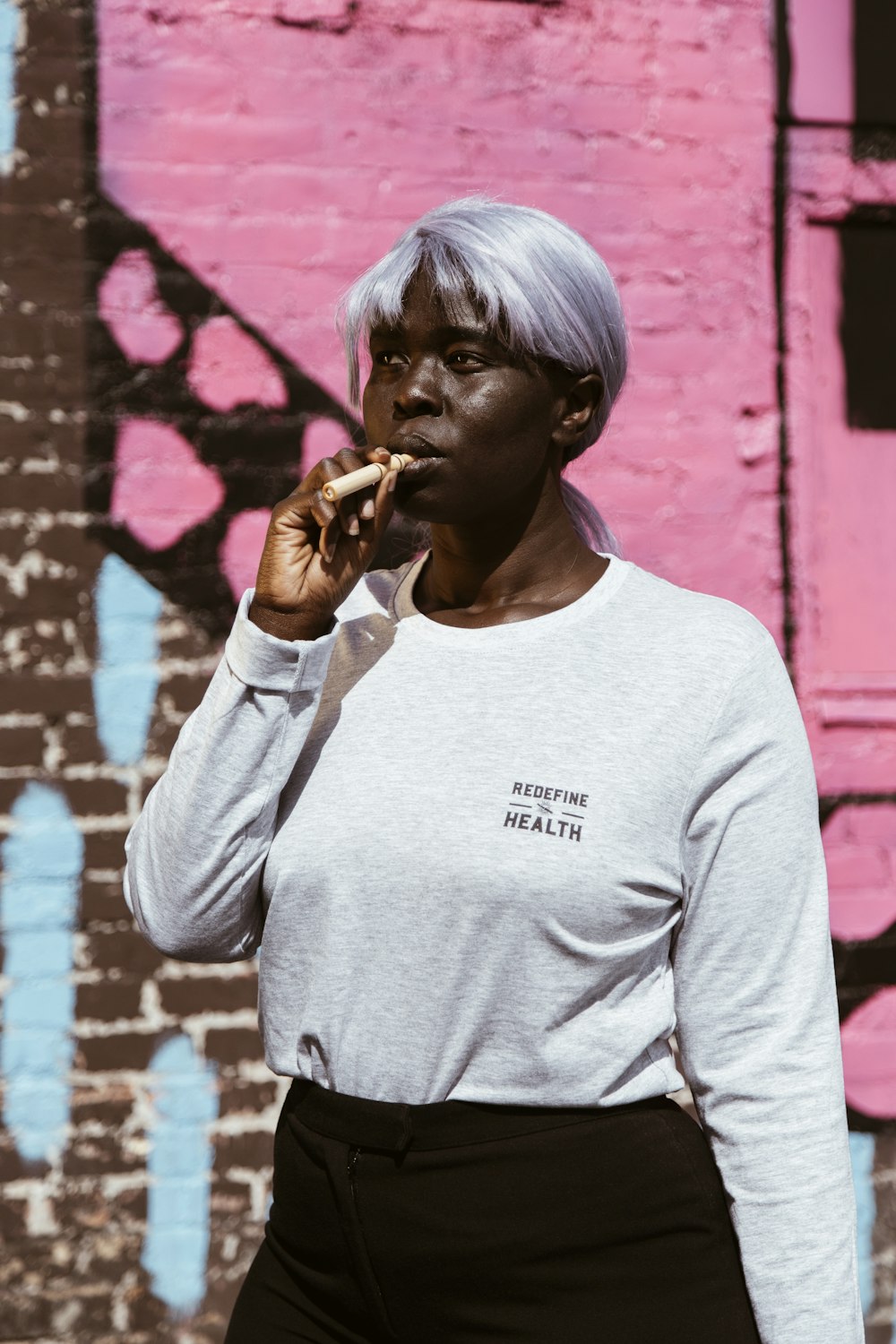 man in gray crew neck long sleeve shirt smoking cigarette