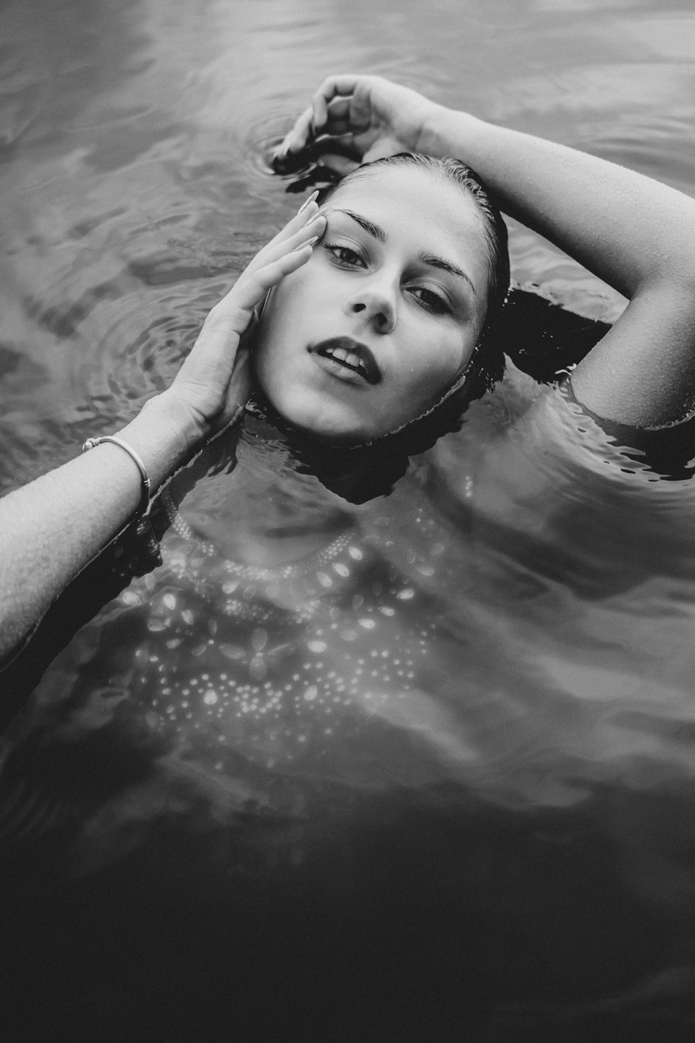 grayscale photo of woman in water