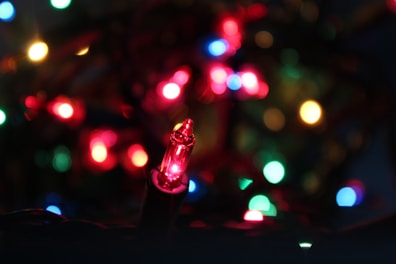 Close-up of a colorful strobe light glowing in a dark room.