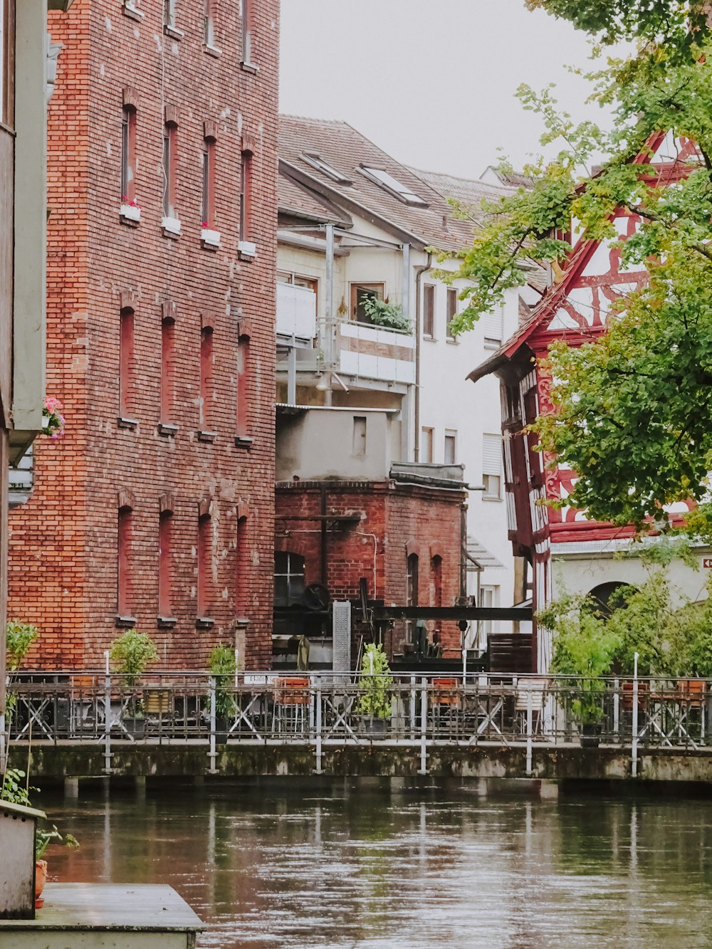 brown brick building near body of water during daytime