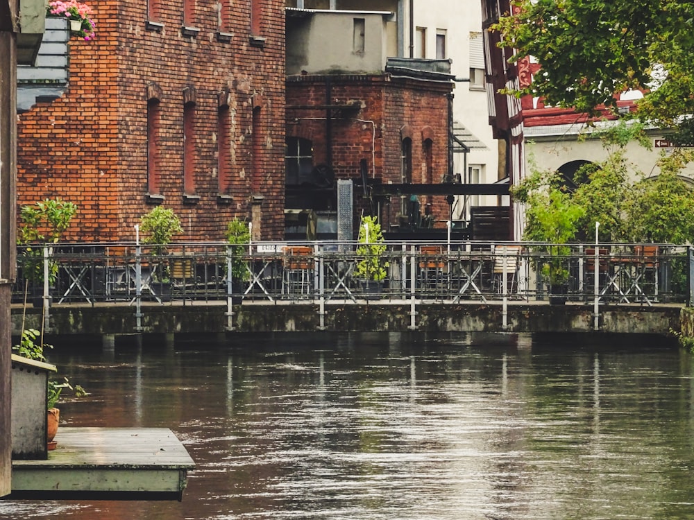 brown brick building beside river during daytime