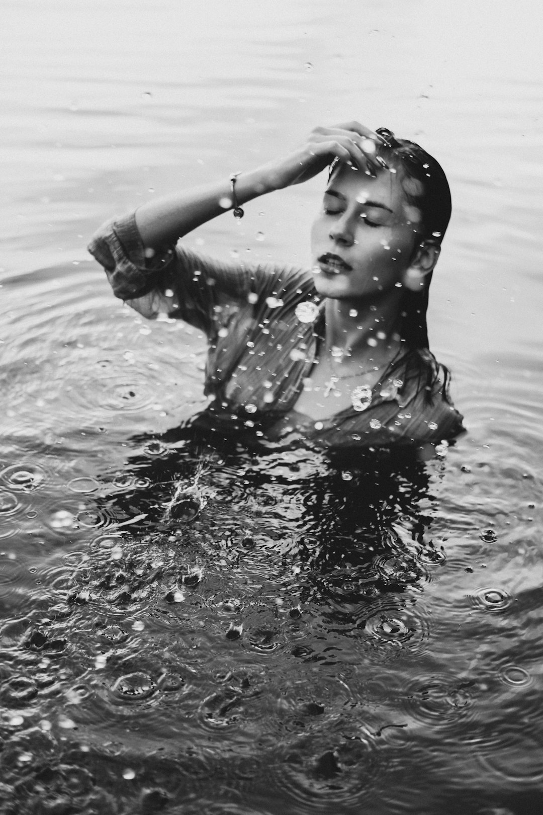 grayscale photo of girl in water