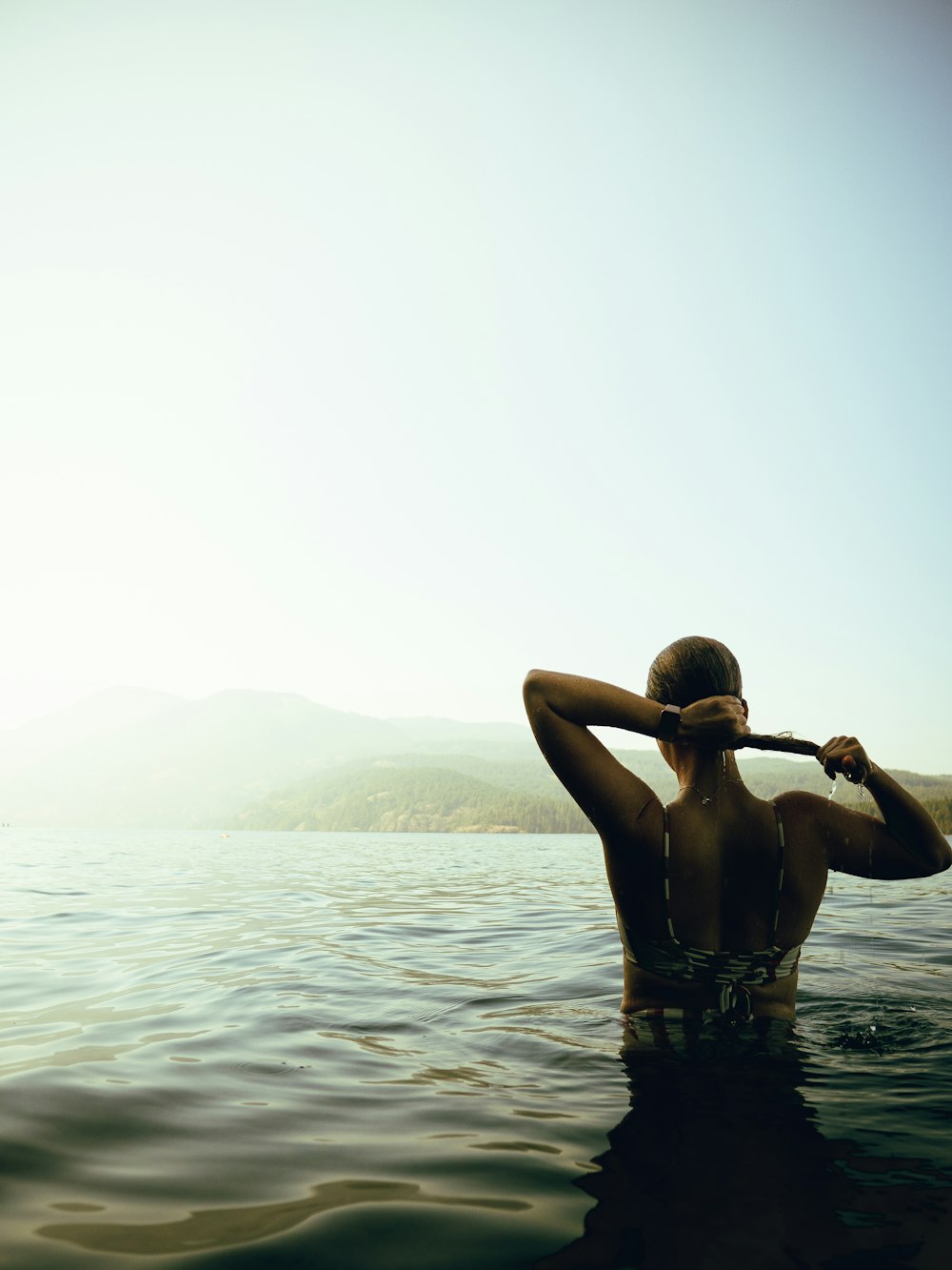 woman in black bikini on water during daytime