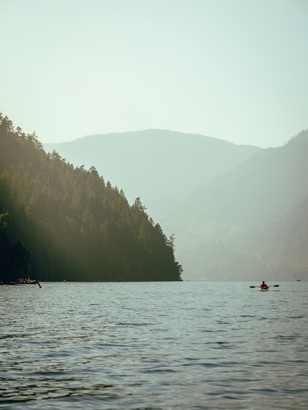 person riding on boat on lake during daytime