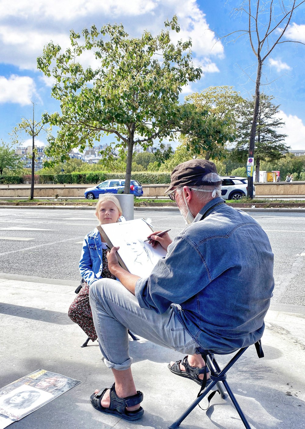 man in blue hoodie sitting on chair reading book