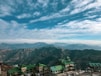 green and white houses on mountain under blue sky during daytime