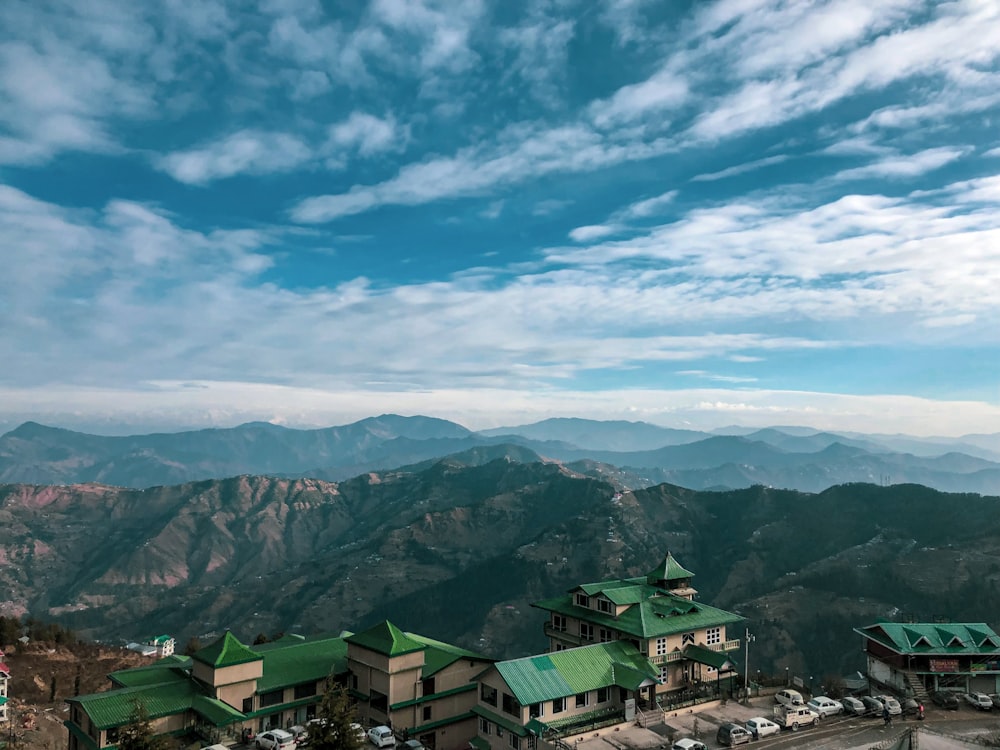 green and white houses on mountain under blue sky during daytime