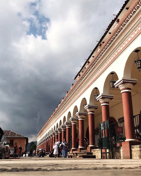 people walking on street near brown and white concrete building during daytime in San Cristobal de las Casas Mexico