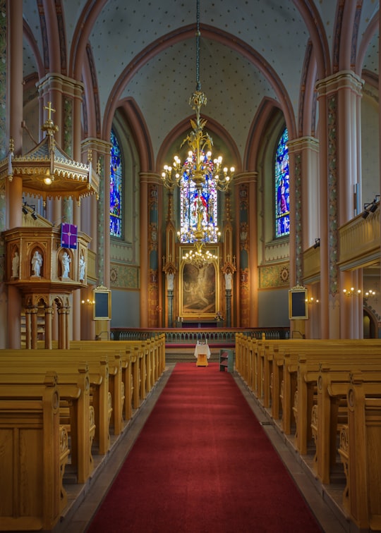 brown wooden bench inside church in Pori Finland