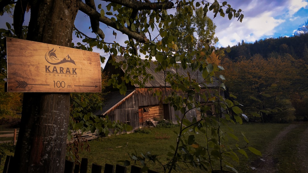 brown wooden house near green trees during daytime