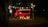 A vintage red food truck is parked in a dimly lit outdoor setting. Large illuminated letters spelling 'vr&w' are placed in front of the truck. String lights are hanging above, casting a warm glow. The environment appears to be a wooded area at night, contributing to a cozy atmosphere.