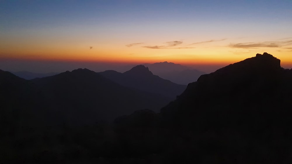 silhouette of mountains during sunset