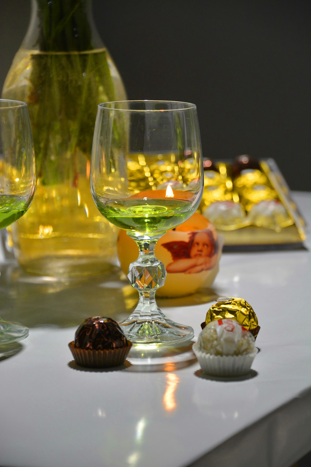 three clear wine glasses on white table