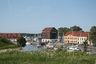 red and white houses near body of water during daytime