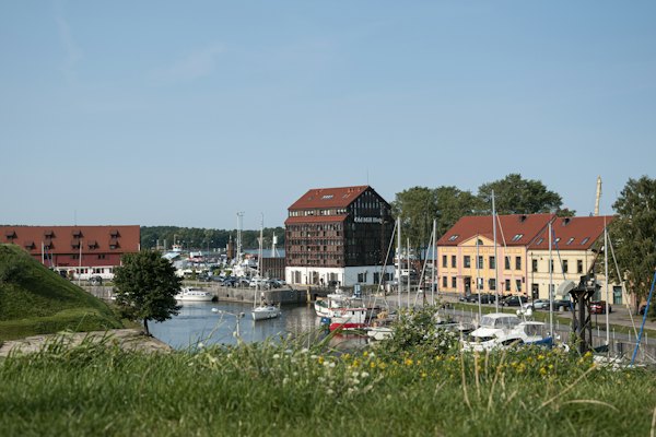 Red and white houses near body of water during daytime — Klaipėda, Lithuania