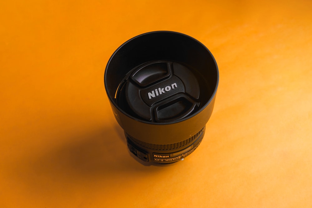 black nikon camera lens cover