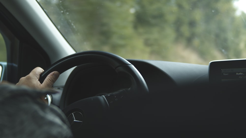 black car steering wheel during daytime