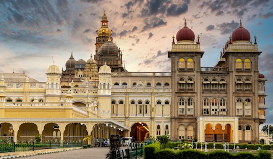 white concrete building under blue sky during daytime in Mysore Palace India