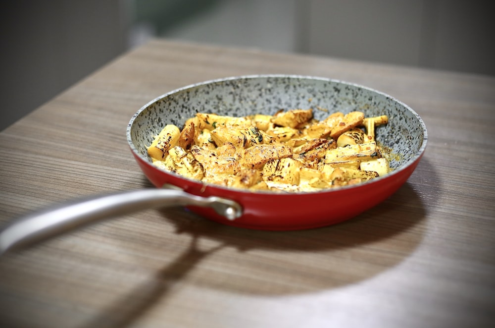 red ceramic bowl with pasta