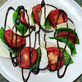sliced tomato on white ceramic plate