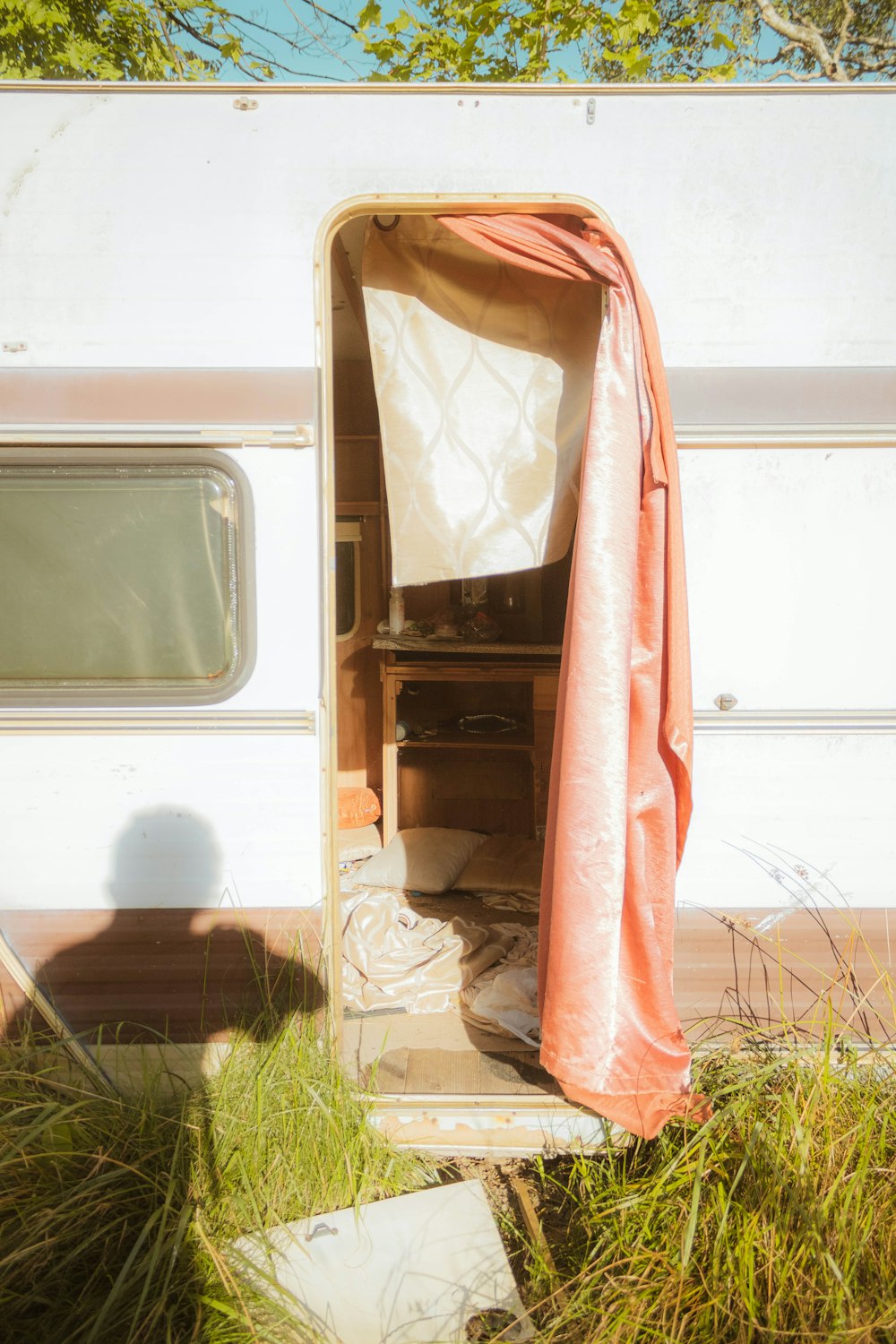 red textile on white wooden window