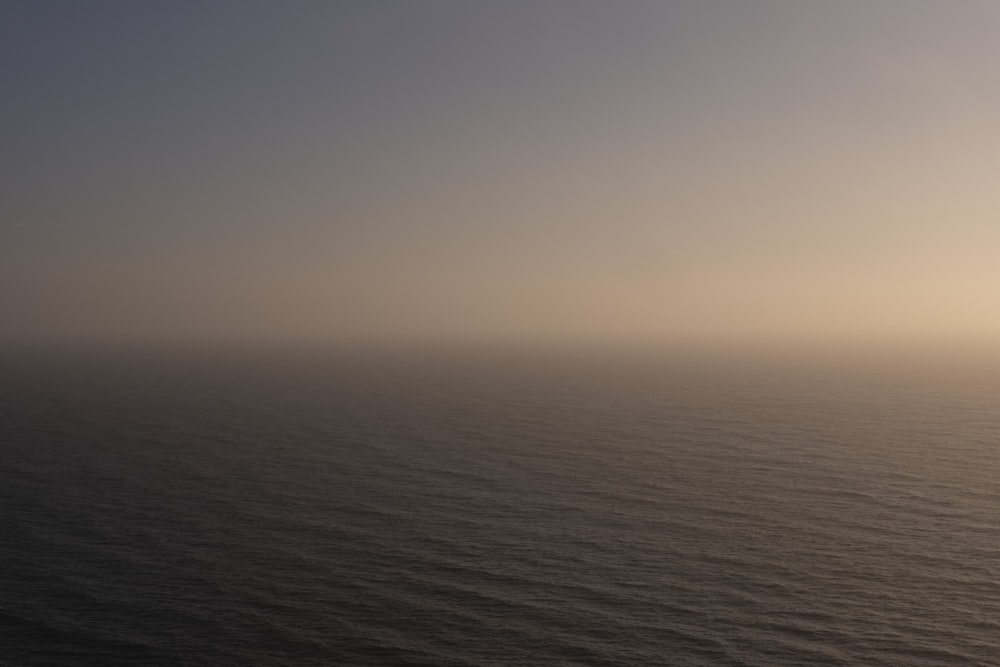 body of water under gray sky