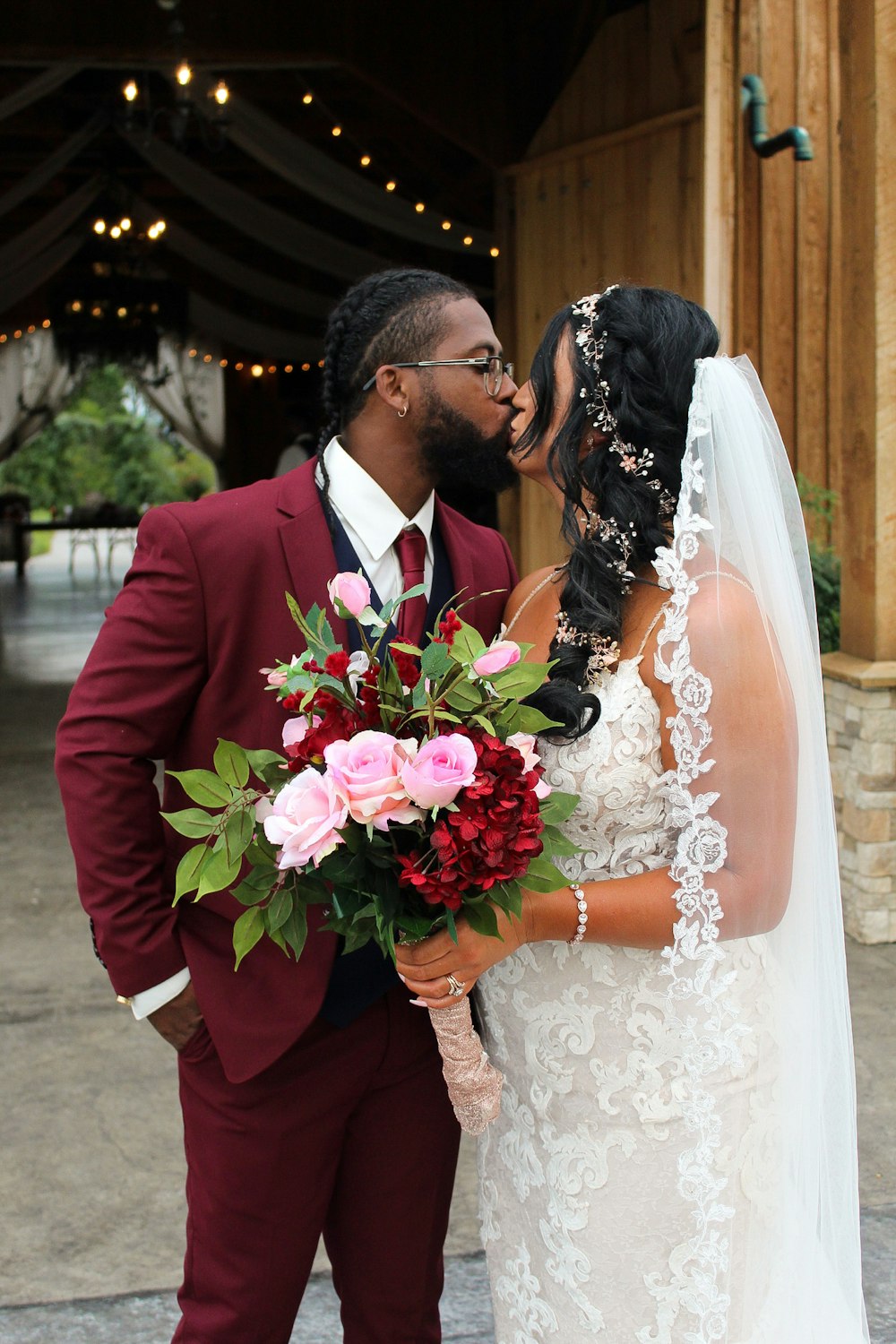 man in red suit and woman in white wedding dress