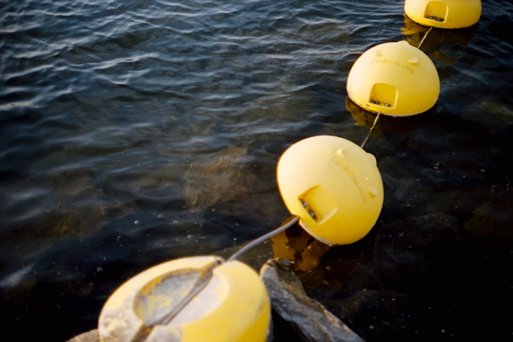 yellow and white round plastic bucket on water