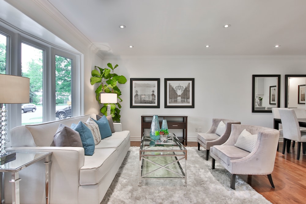 living room with white sofa and glass coffee table