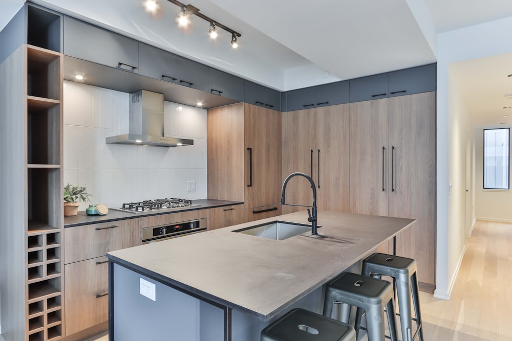 white wooden kitchen cabinet with stainless steel faucet