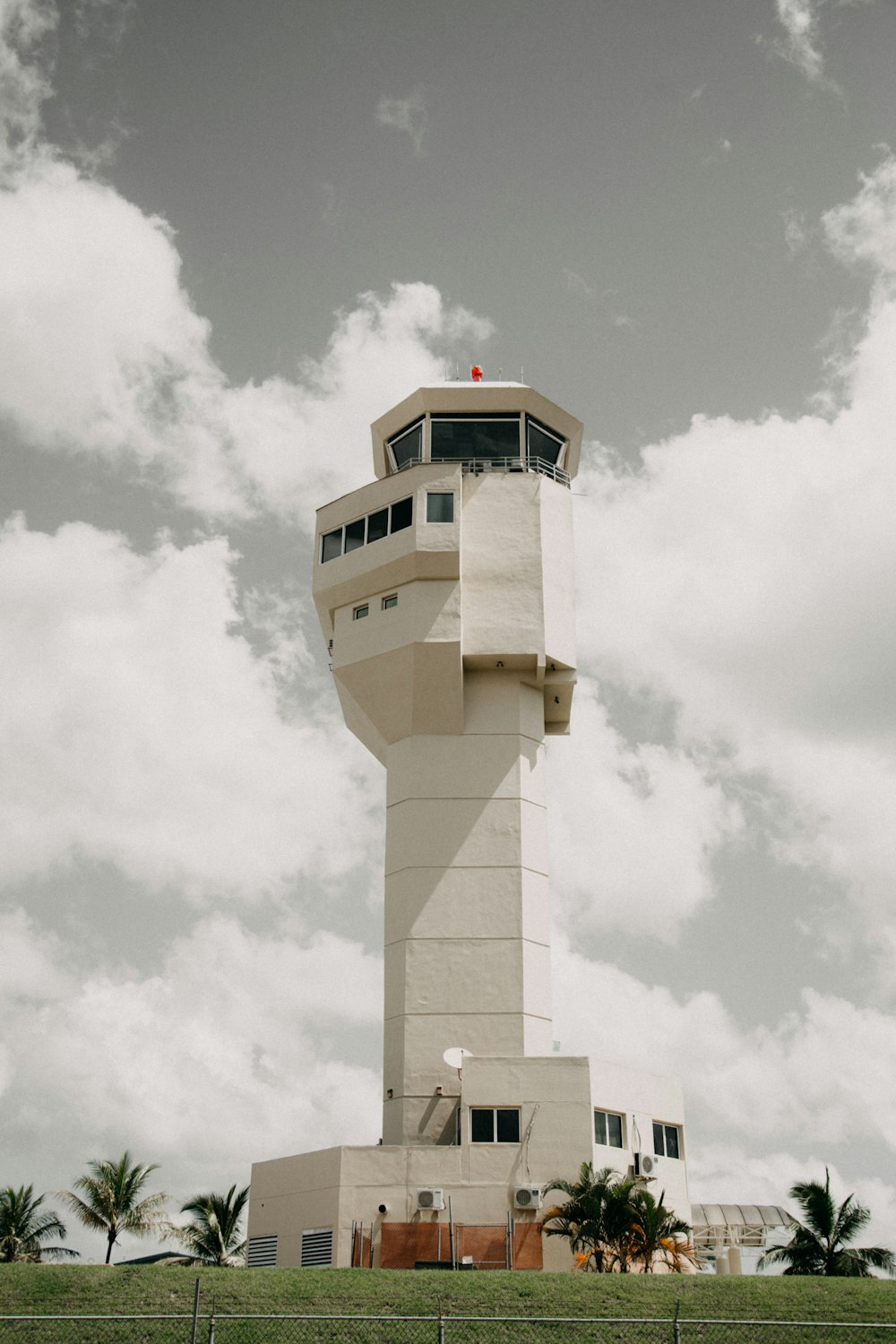 white and brown concrete tower under white clouds