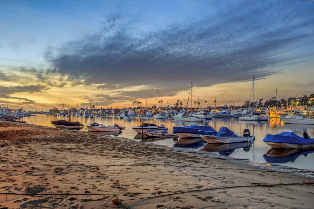 boats on beach during sunset
