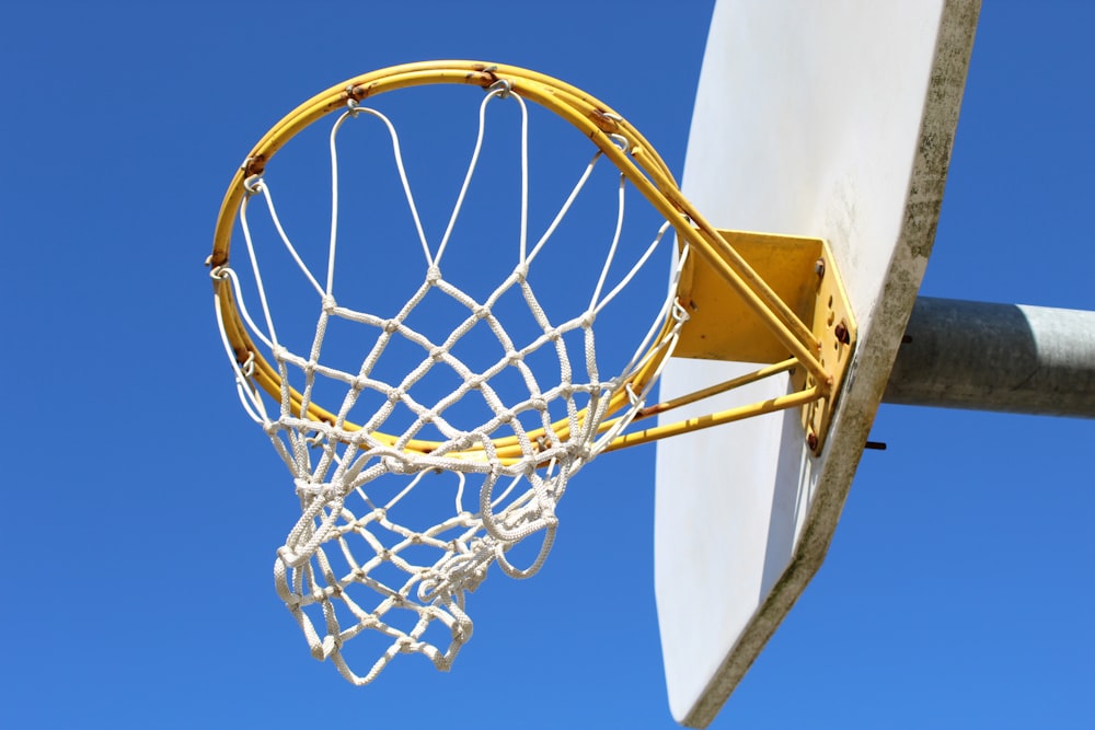 yellow basketball hoop under blue sky during daytime