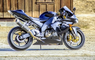 Sleek modern motorcycle in black and gold colors on a dark background