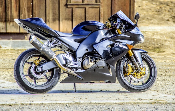Sleek modern motorcycle in black and gold colors on a dark background