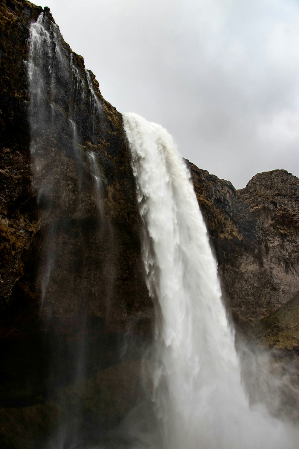 a very tall waterfall with water pouring out of it