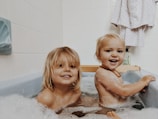 A group of children smiling in a clean bathroom.