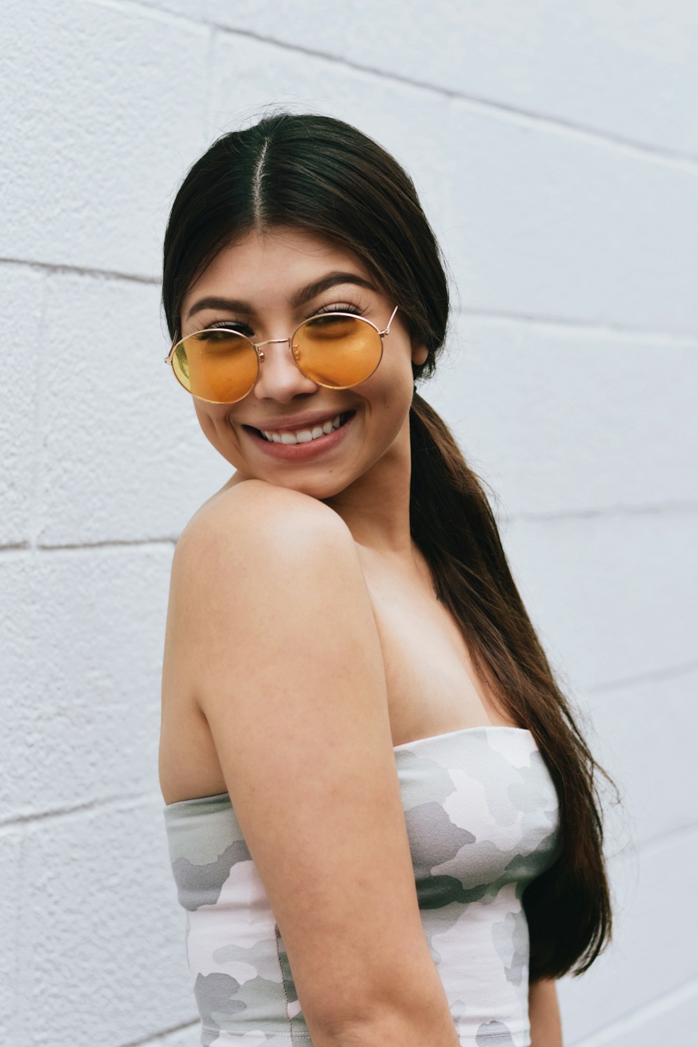 woman in white tube top wearing sunglasses