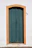 Painter carefully restoring a vintage wooden door in a bright, classic-style home.
