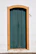 Painter carefully restoring a vintage wooden door in a bright, classic-style home.
