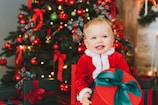 Close-up of a child smiling brightly while listening to Santa's personalized message.